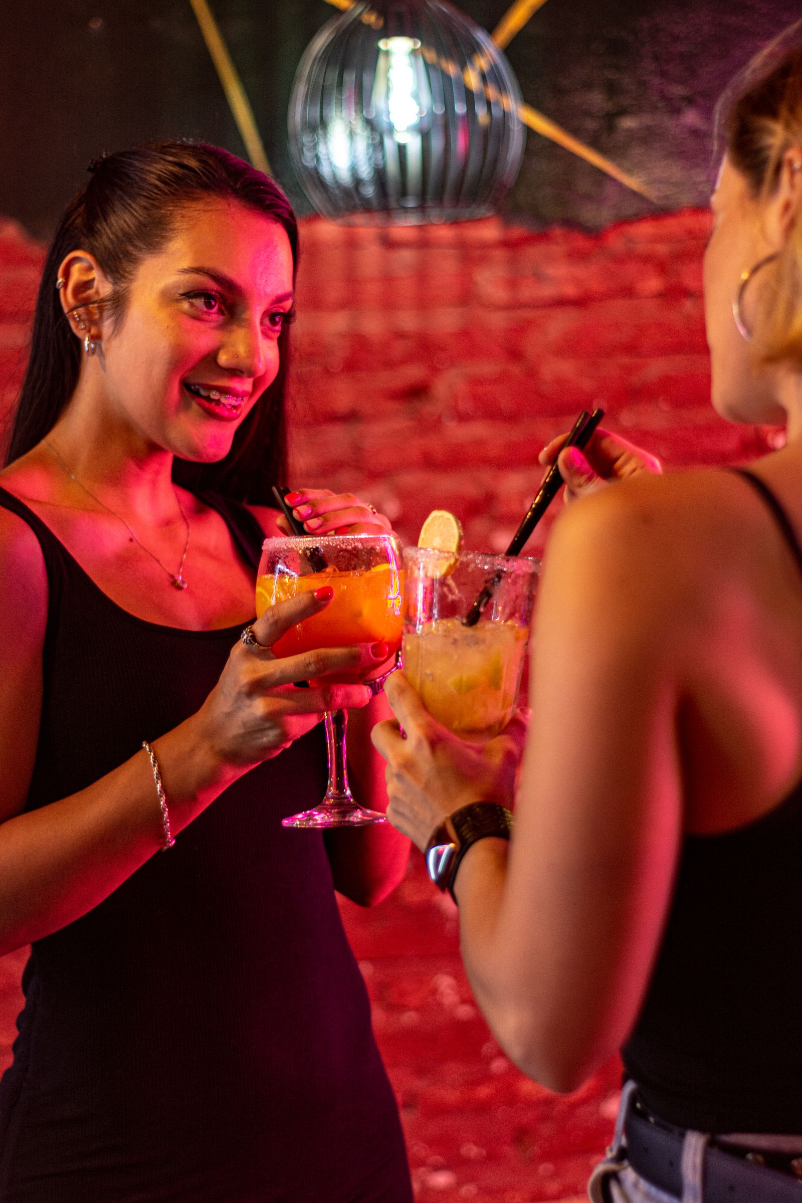 Friends laughing over cocktails at a local bar