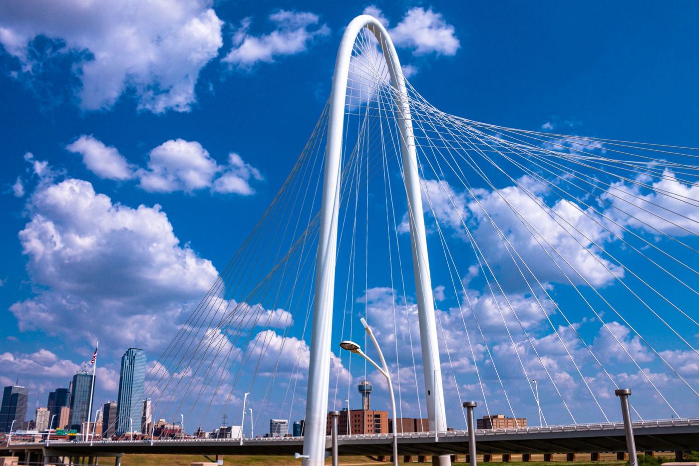 The Margaret Hunt Hill Bridge arch over the Trinity River with the Dallas skyline