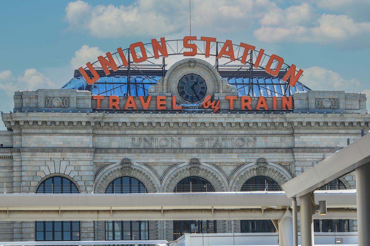 Denver Union Station with its Travel by Train sign
