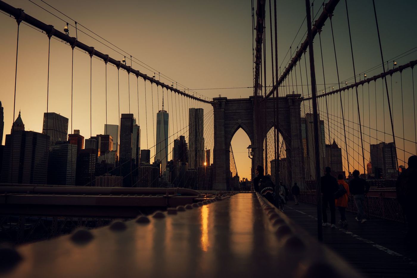 The Brooklyn Bridge walkway at sunset with the Lower Manhattan skyline, New York City