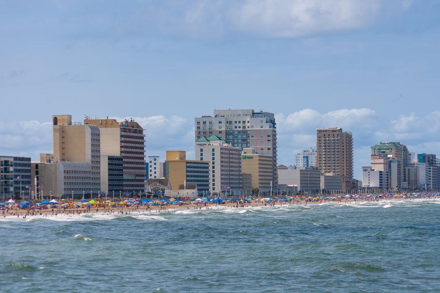 The Virginia Beach oceanfront, with the hotel strip, a crowded beach and surf