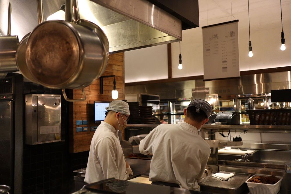 Two chefs working the line during service