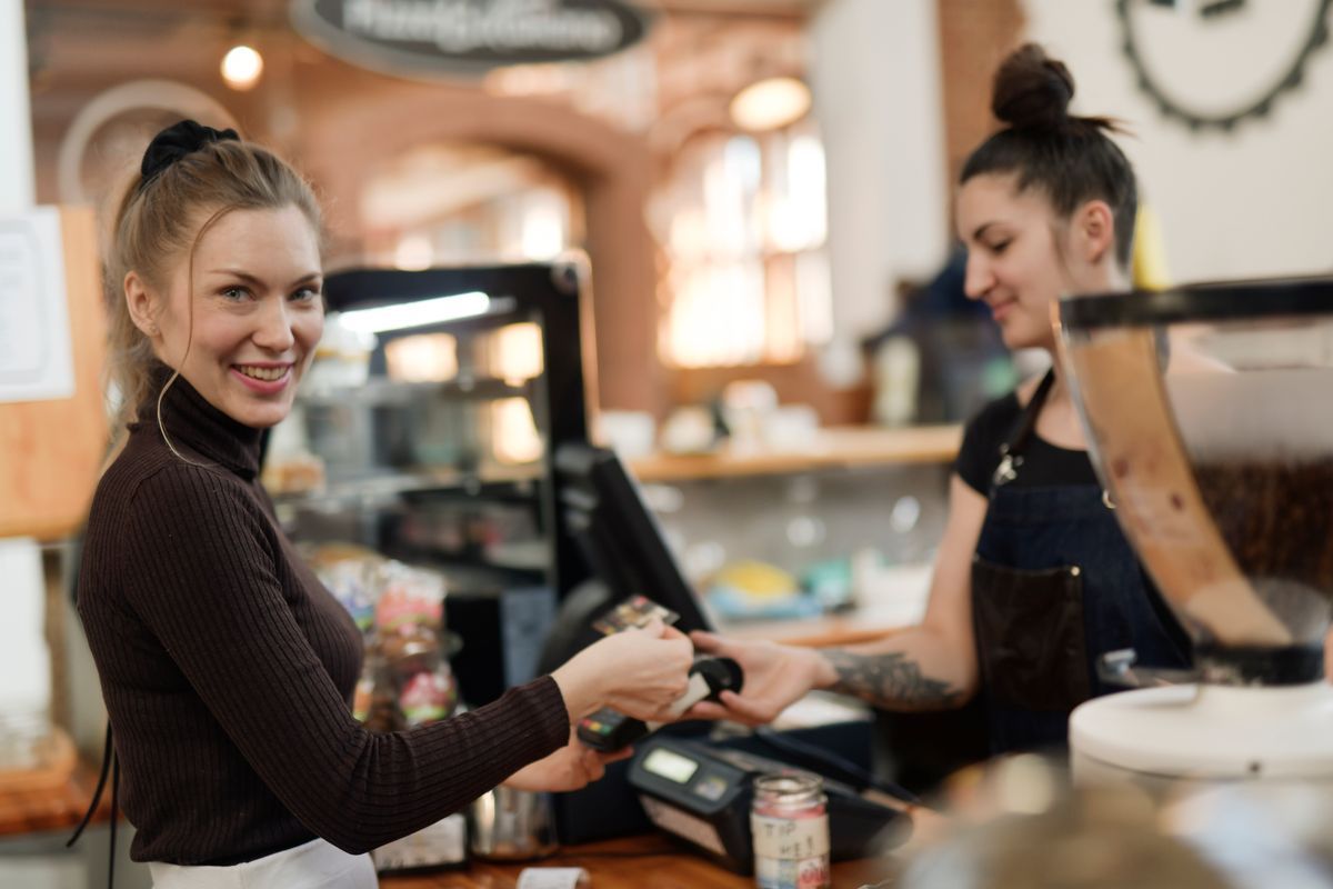 A customer paying at the counter
