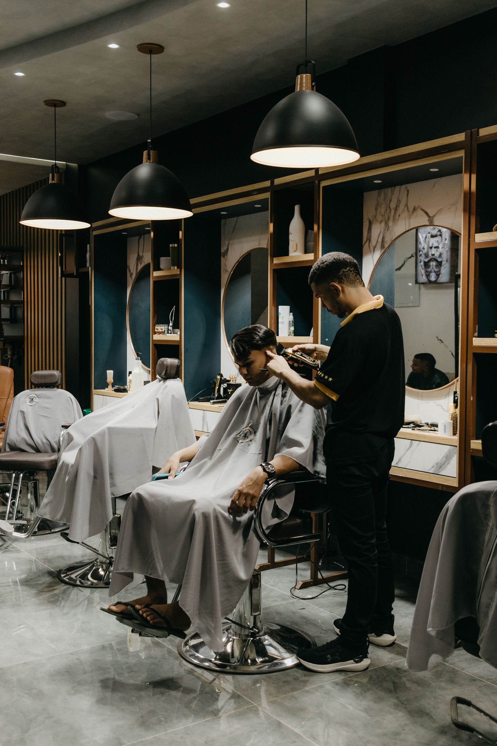 A stylist working on a client in a local barbershop