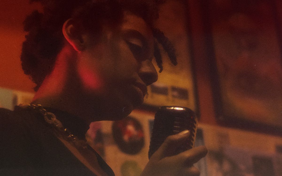 A singer at the microphone in a small room