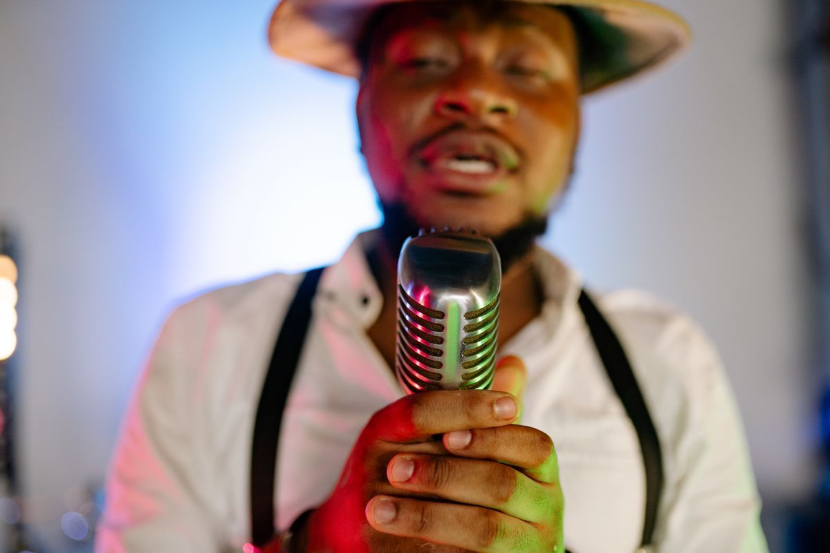 A singer holding a vintage microphone, close up